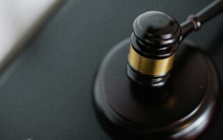 Dark brown gavel resting on a wooden block