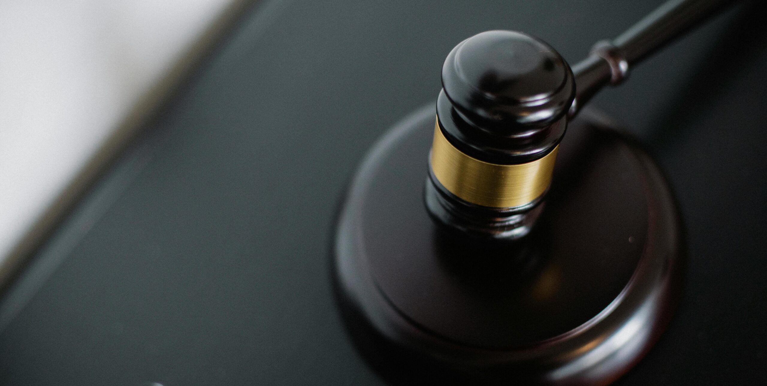 Dark brown gavel resting on a wooden block
