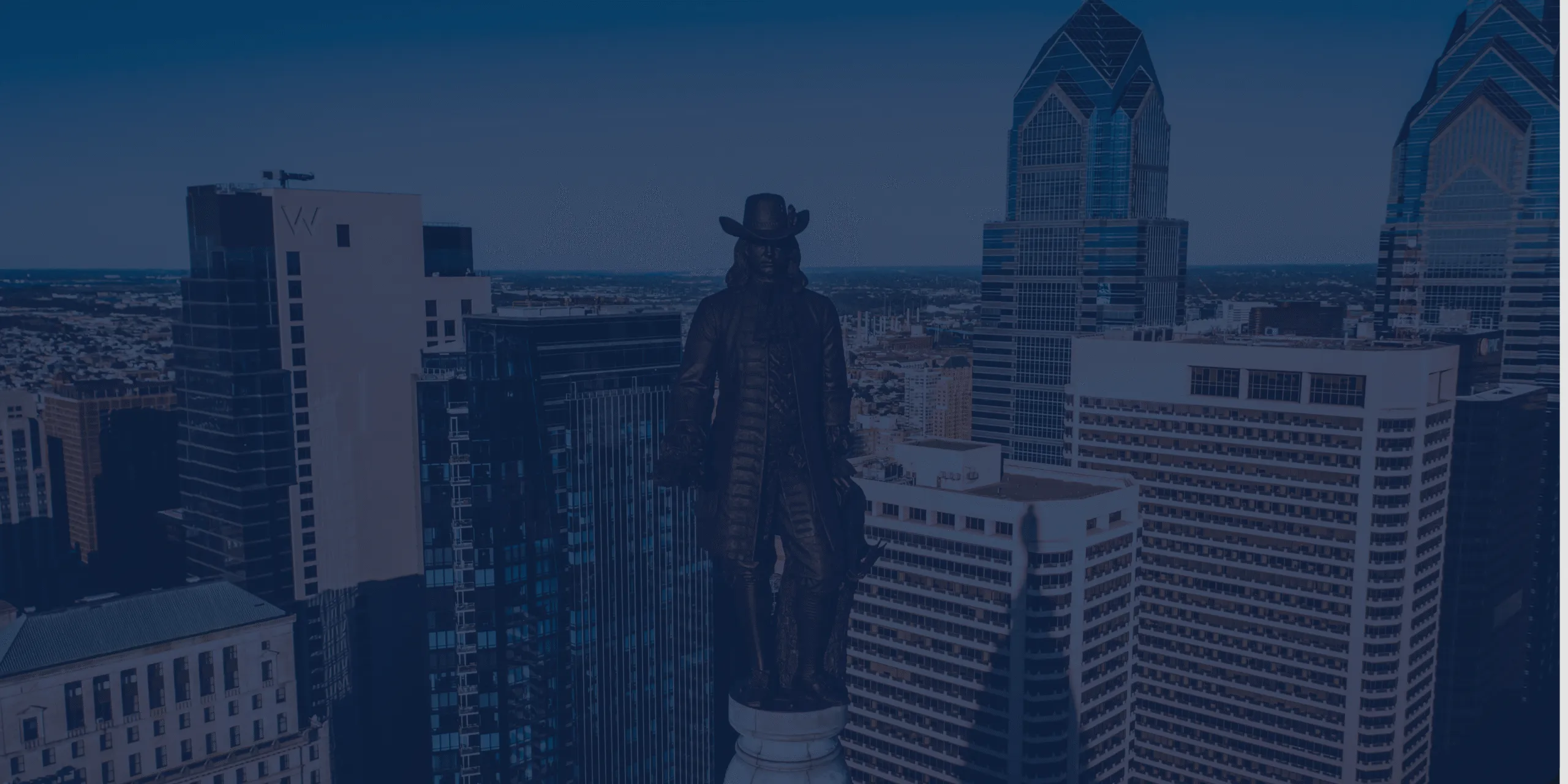 Close-up of William Penn statute in Philadelphia skyline